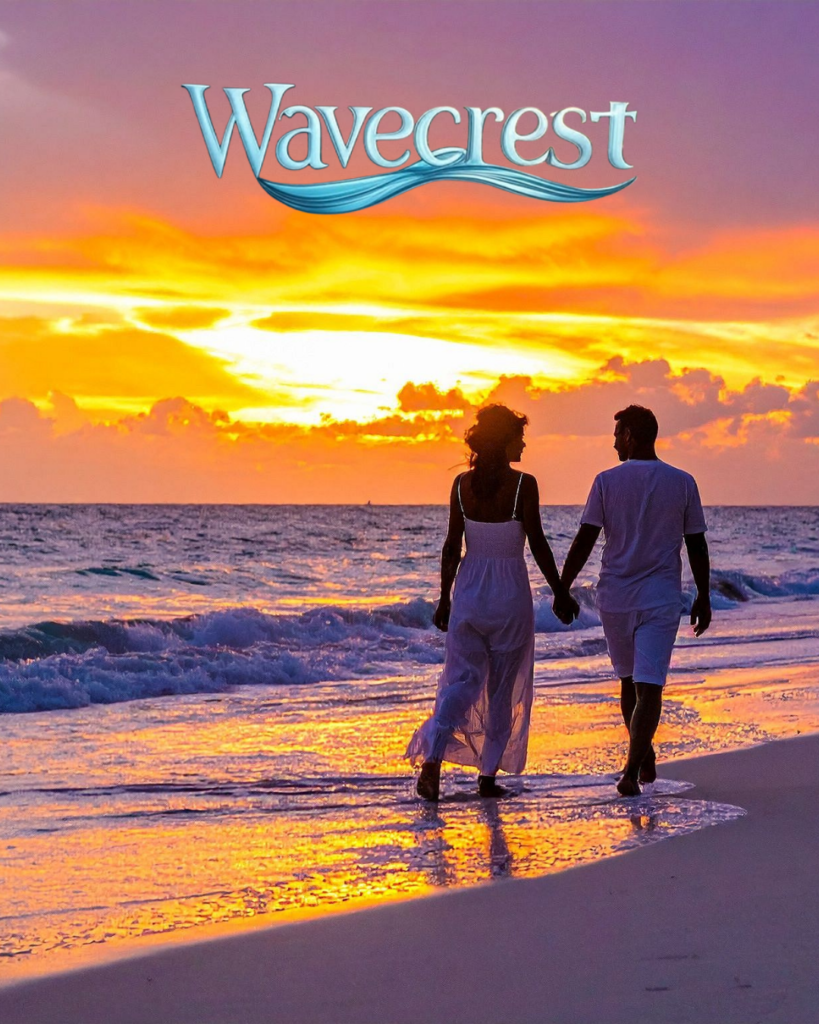 Couple walking along the beach at sunset on Okaloosa Island along the Gulf of America near Wavecrest Lodge