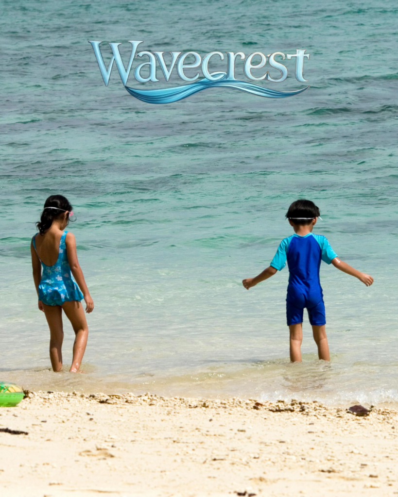 Children playing in the emerald water on Okaloosa Island beach near Wavecrest Lodge and Destin Florida
