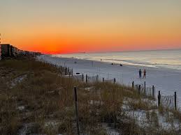 Sunset over the white sand beach on Okaloosa Island along the Gulf of America near Destin Florida