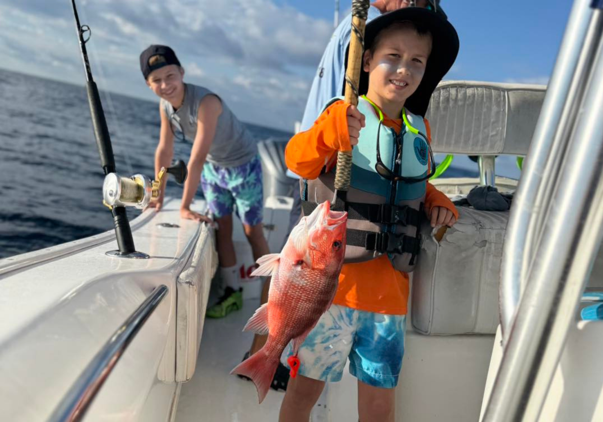 Child holding fish on Code Blue Fishing Charter in Destin Florida