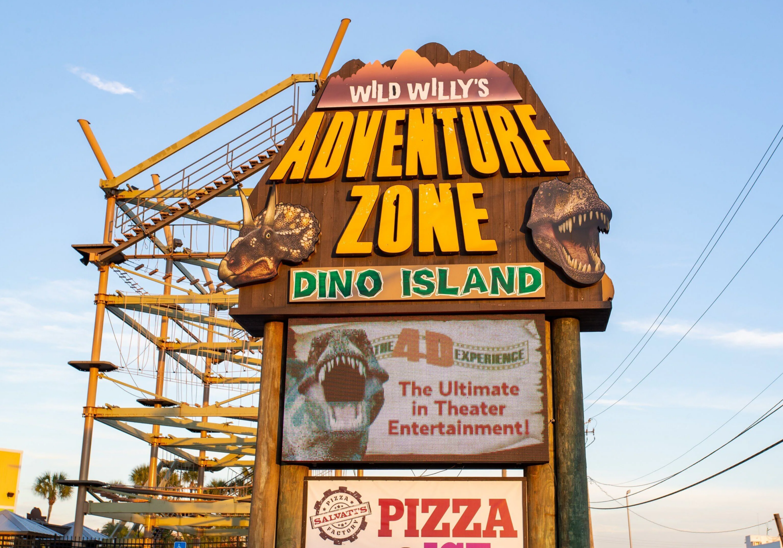 Wild Willy’s Adventure Zone sign on Okaloosa Island in Fort Walton Beach featuring a dinosaur-themed family attraction