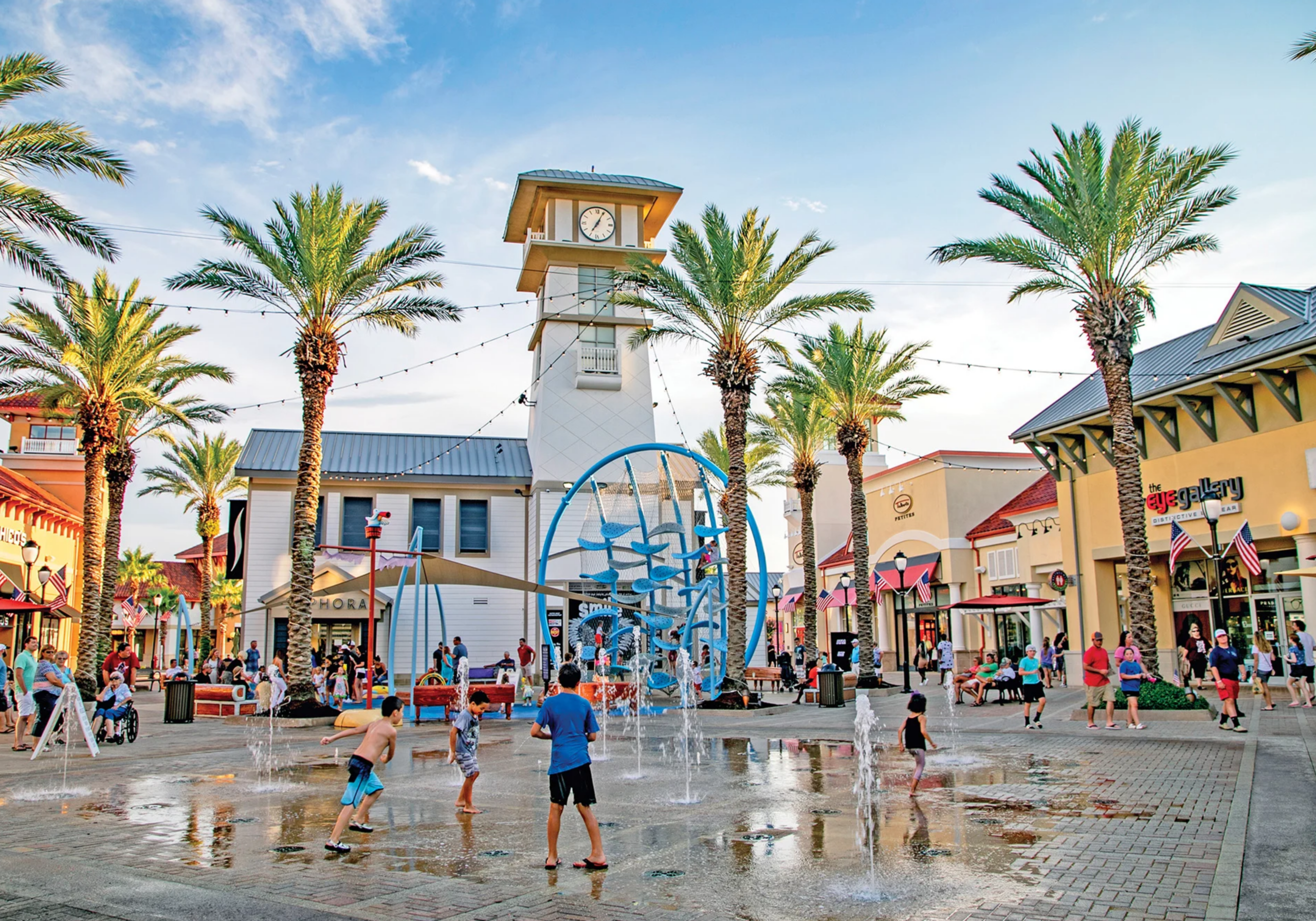 Destin Commons outdoor shopping center with fountain, palm trees, and stores