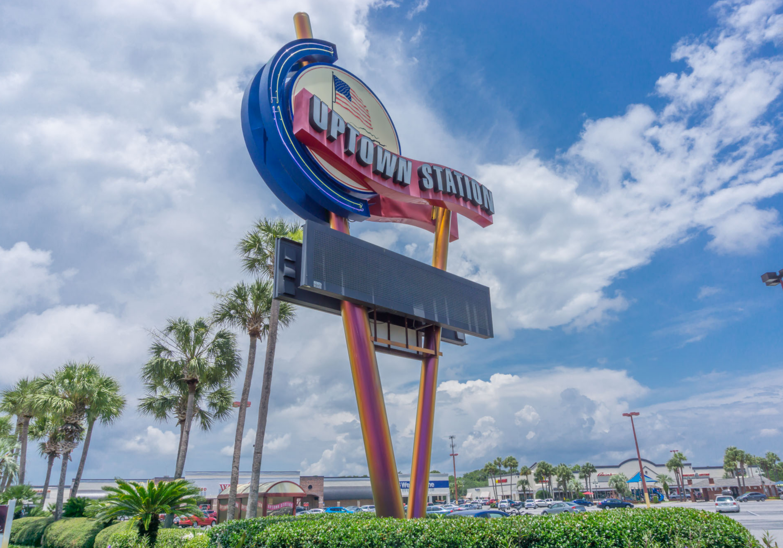 Uptown Station shopping center sign in Fort Walton Beach with palm trees