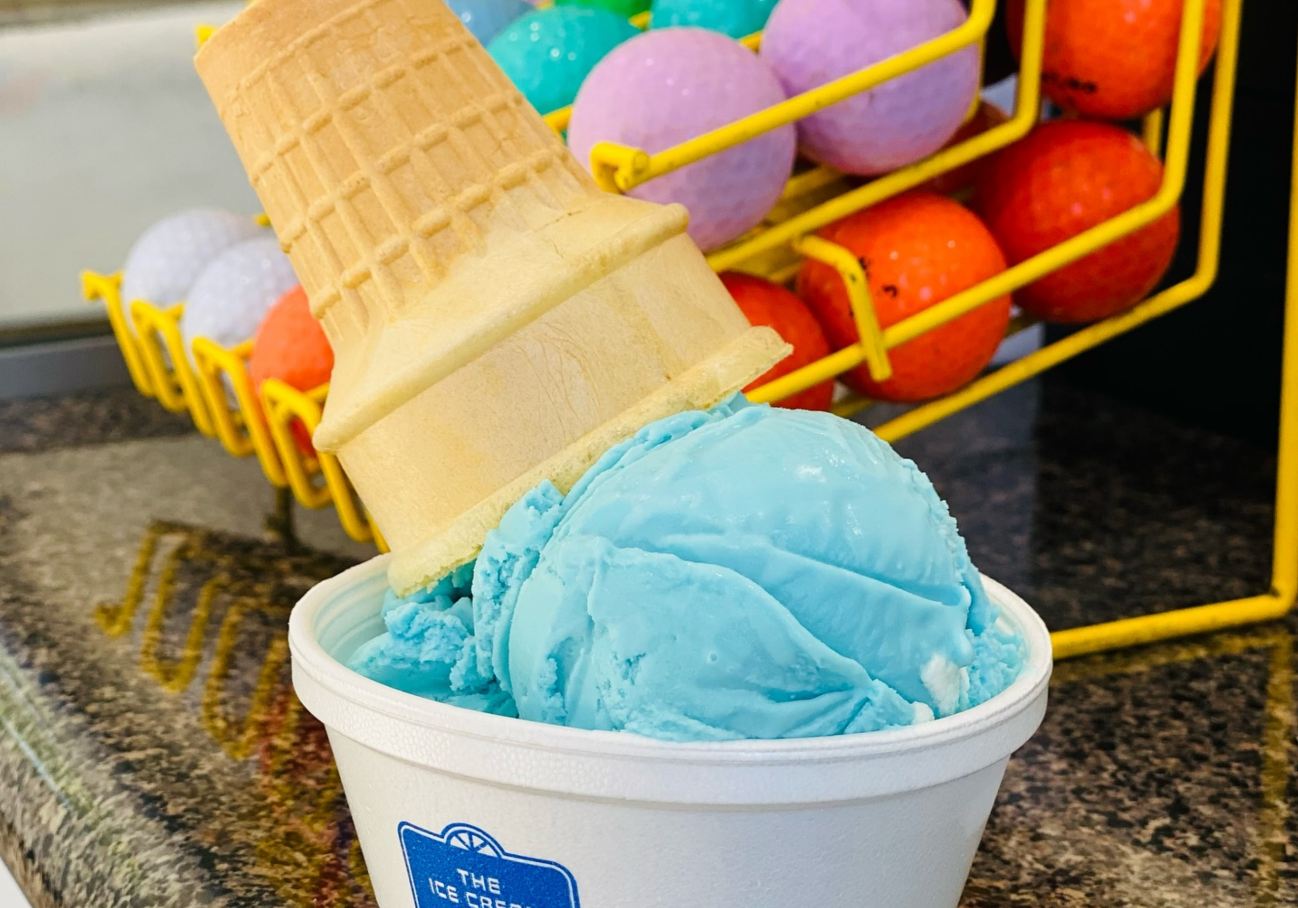 Mini golf course with colorful golf balls and ice cream treats at Okaloosa National Mini Golf & Ice Cream in Fort Walton Beach