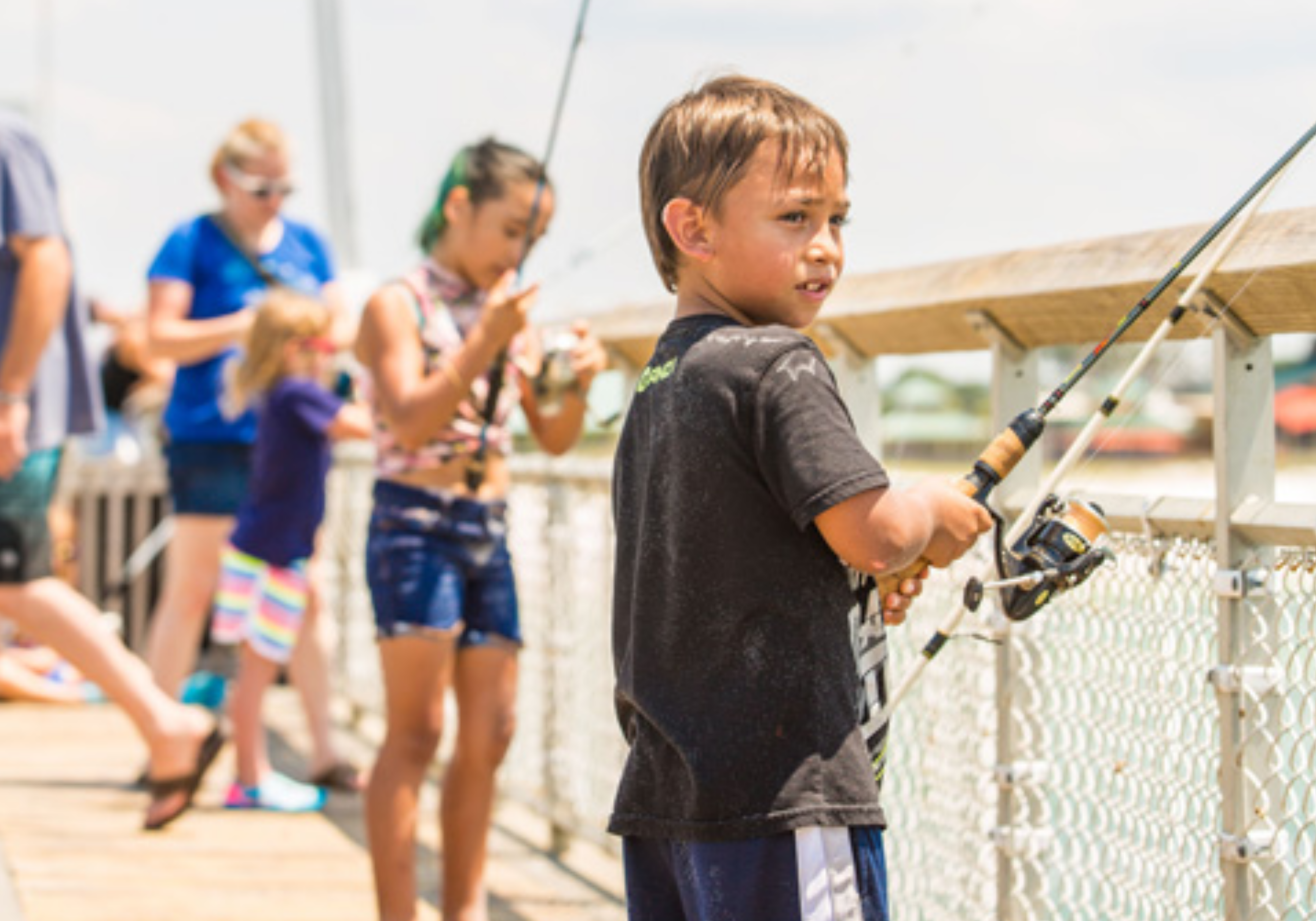 Child fishing off Okaloosa Island Pier in Fort Walton Beach with ocean views
