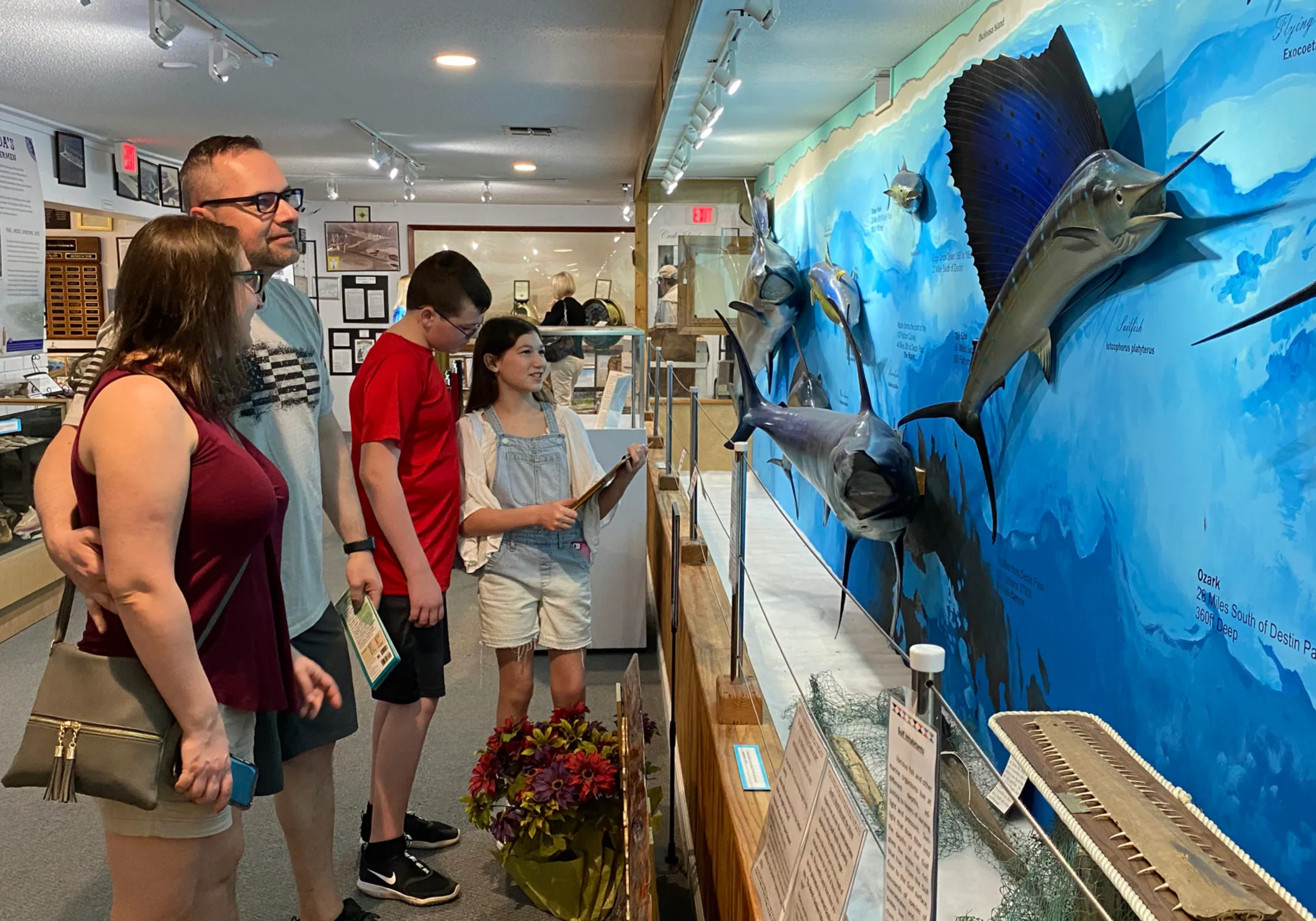 Visitors exploring exhibits at the Destin History and Fishing Museum with marine displays