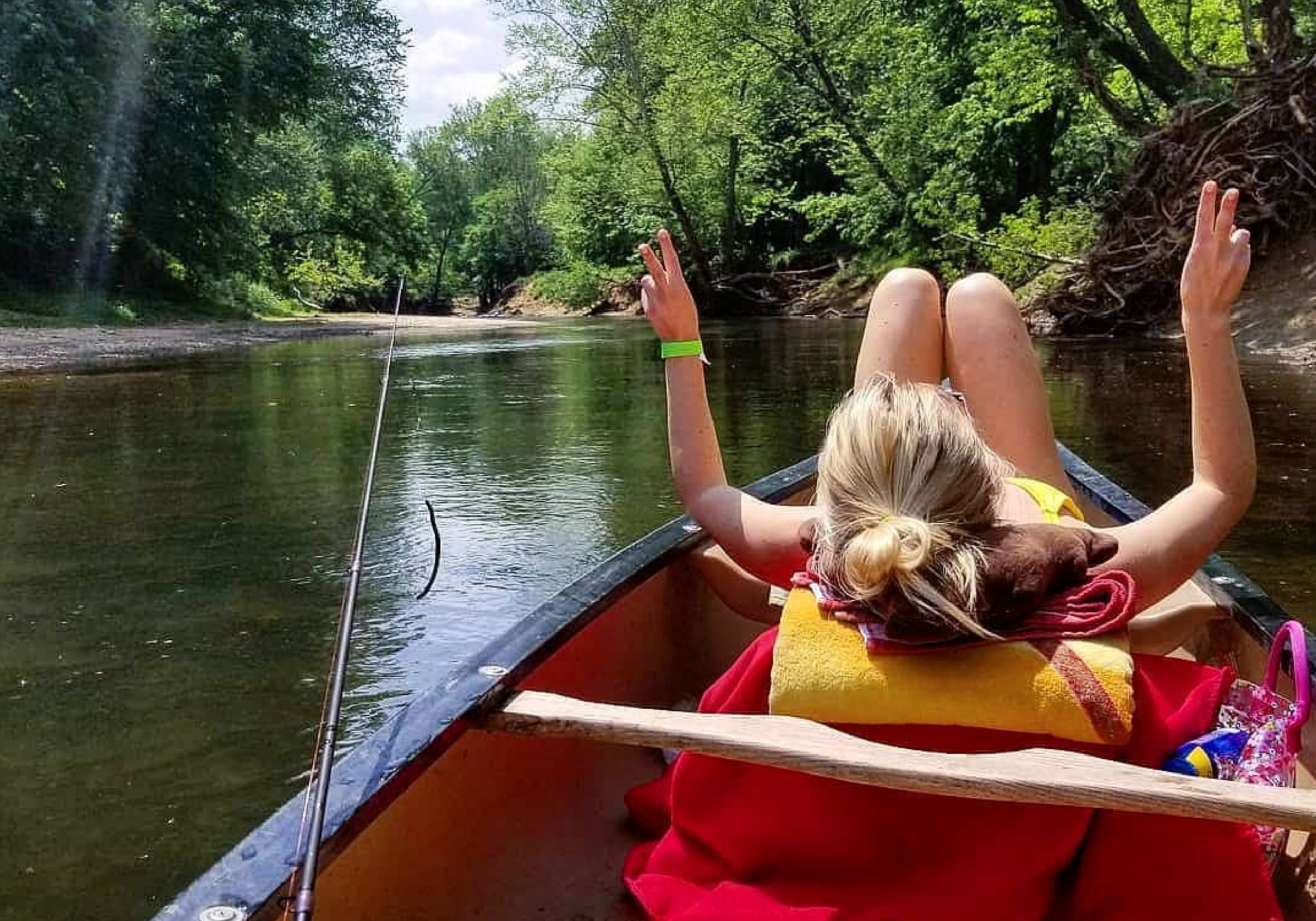 Girl canoeing on Blackwater River at Blackwater Joe’s surrounded by clear water and natural scenery