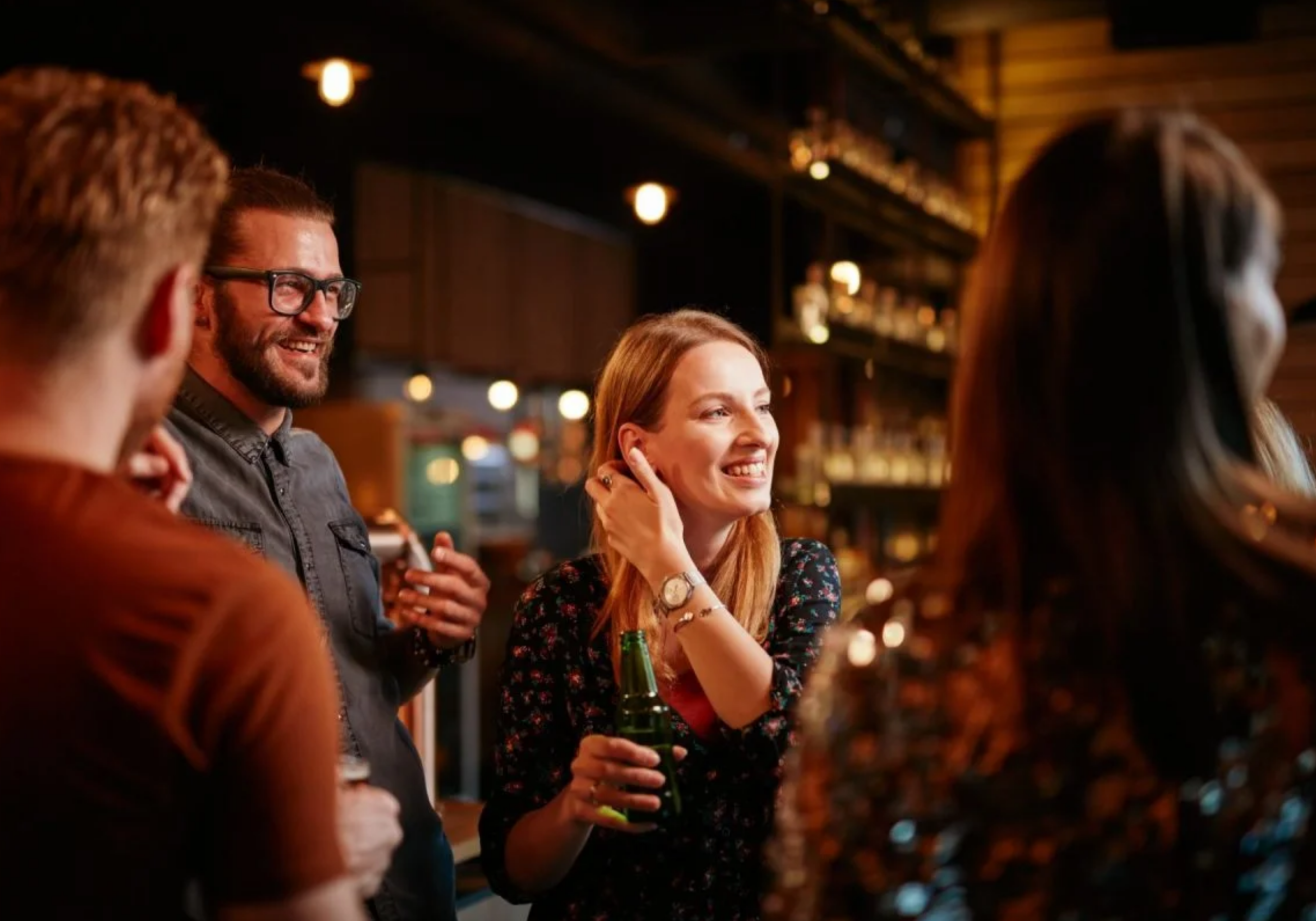 Friends enjoying drinks and live music during a Destin nightlife evening near Crab Island