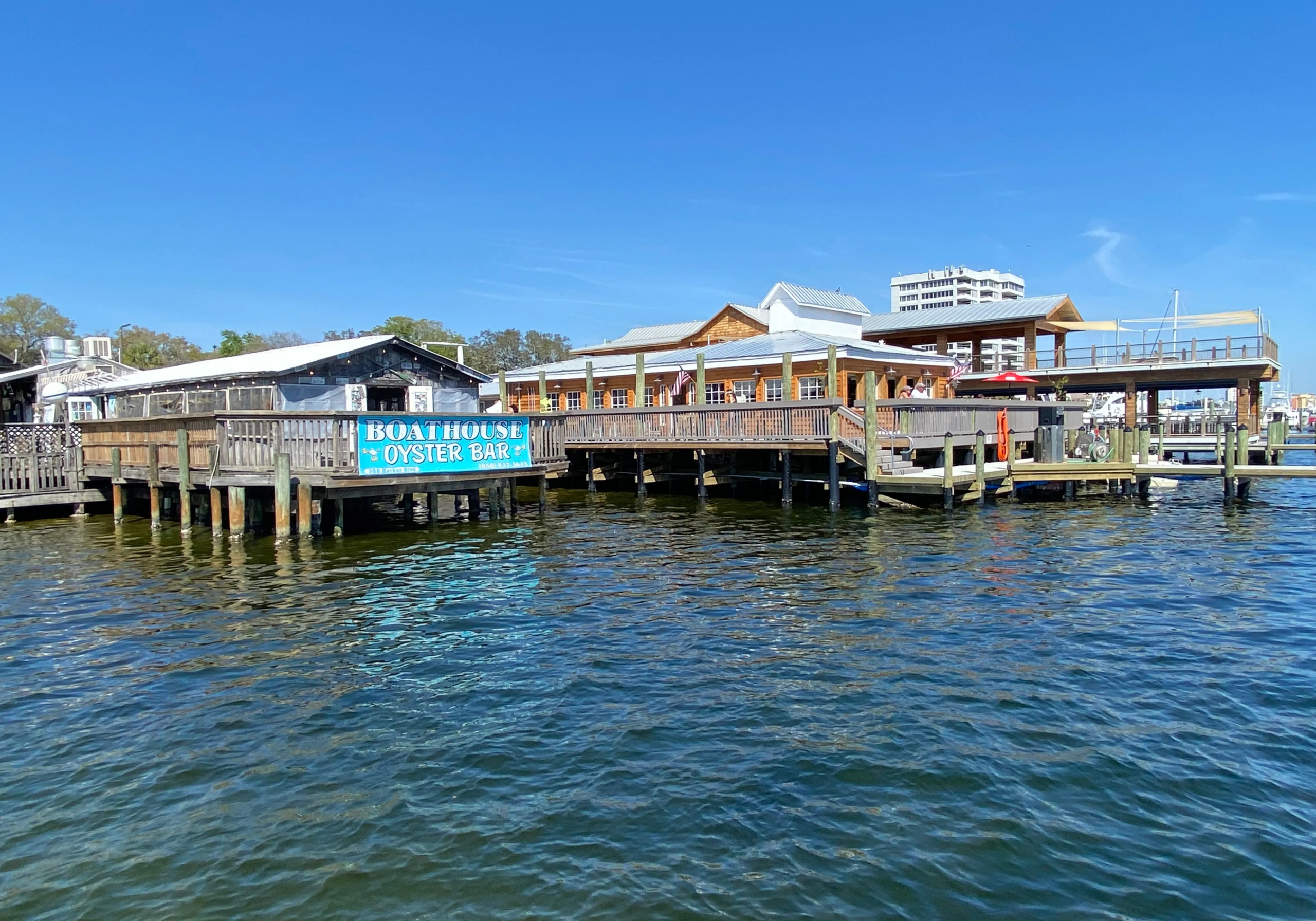 The Boathouse waterfront restaurant and bar in Destin Harbor with docks and open-air seating