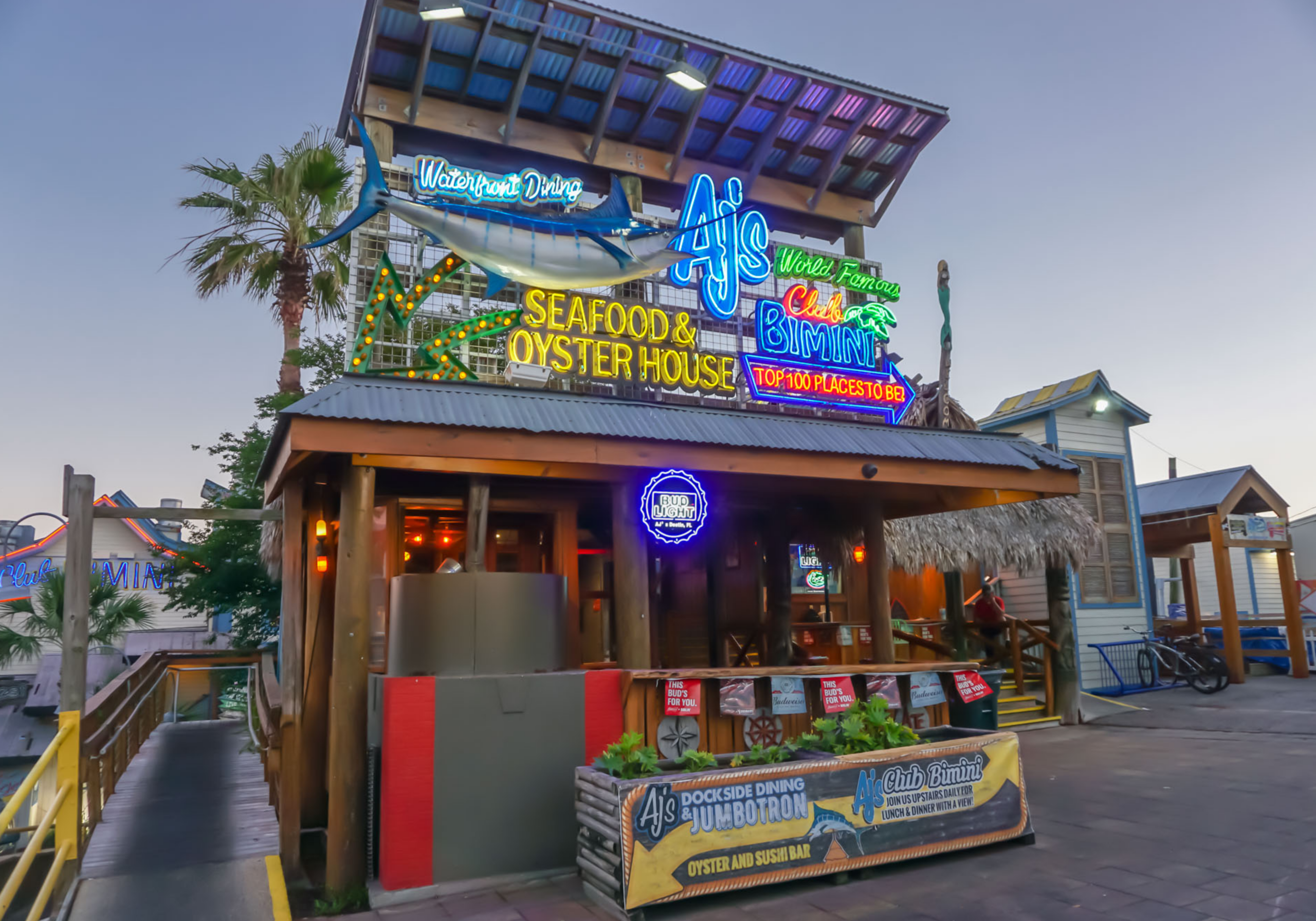 AJ’s Seafood and Oyster Bar in Destin Harbor with colorful exterior and lively nightlife atmosphere