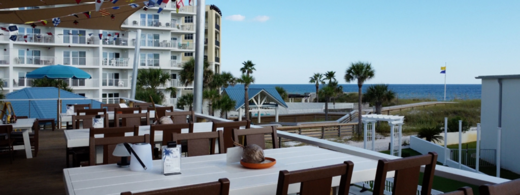Outdoor beachfront restaurant seating in Fort Walton Beach with ocean views