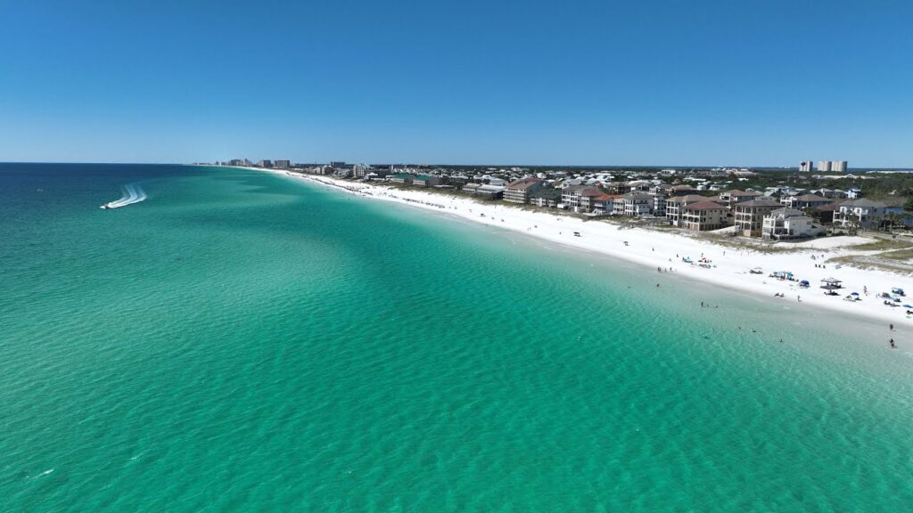 White sand beach and clear emerald water on Okaloosa Island along the Gulf of America near Fort Walton Beach, Florida