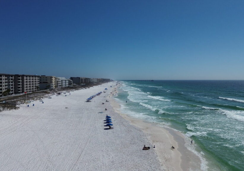 Beachfront hotel view on Okaloosa Island with white sand and emerald water along the Gulf of America