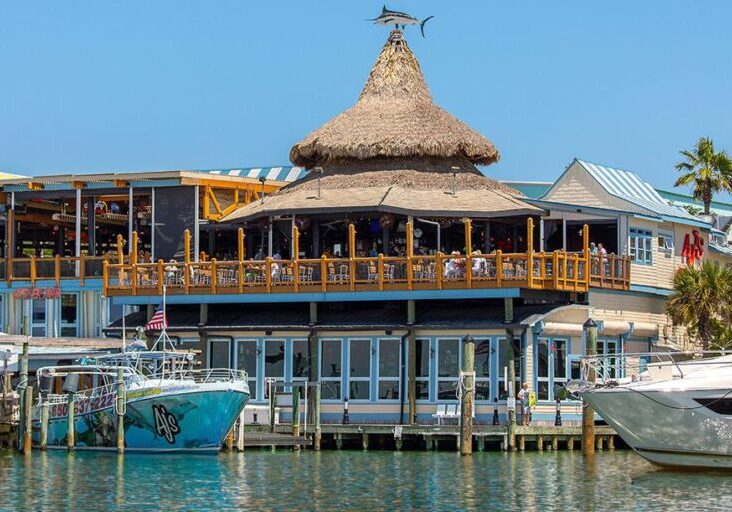 AJ’s Seafood and Oyster Bar on Destin Harbor with waterfront views and boats along the boardwalk